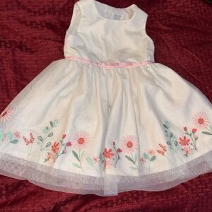 Carters infant pink and white dress with flower design.